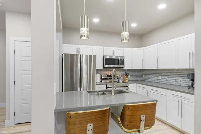 a kitchen that has a table and chairs in it