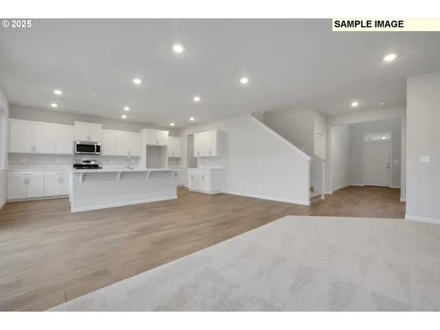 a view of kitchen with kitchen island and stainless steel appliances