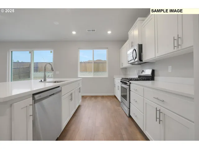 a kitchen with cabinets and window