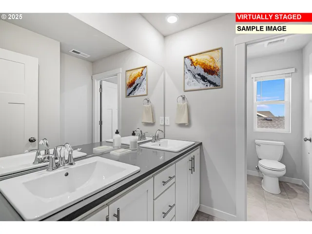 a bathroom with a sink double vanity and a toilet