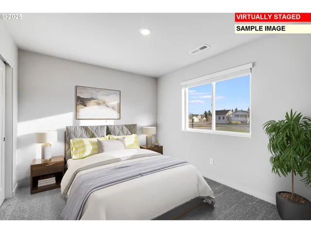 a bedroom with a bed and a potted plant