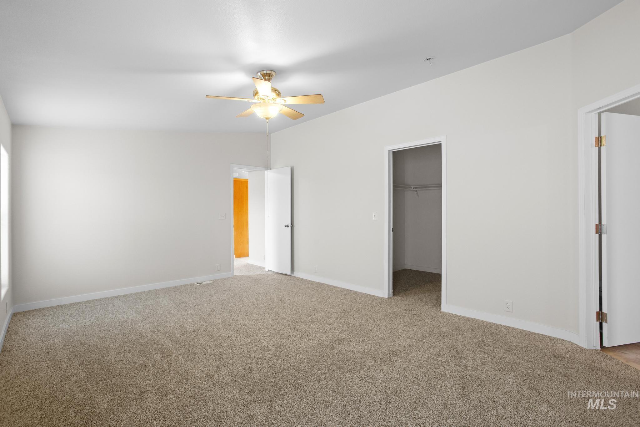 15190 Oasis Road Caldwell, ID 83607 - Photo 20 of 36 Carpeted room with a ceiling fan, white walls, and a recessed window