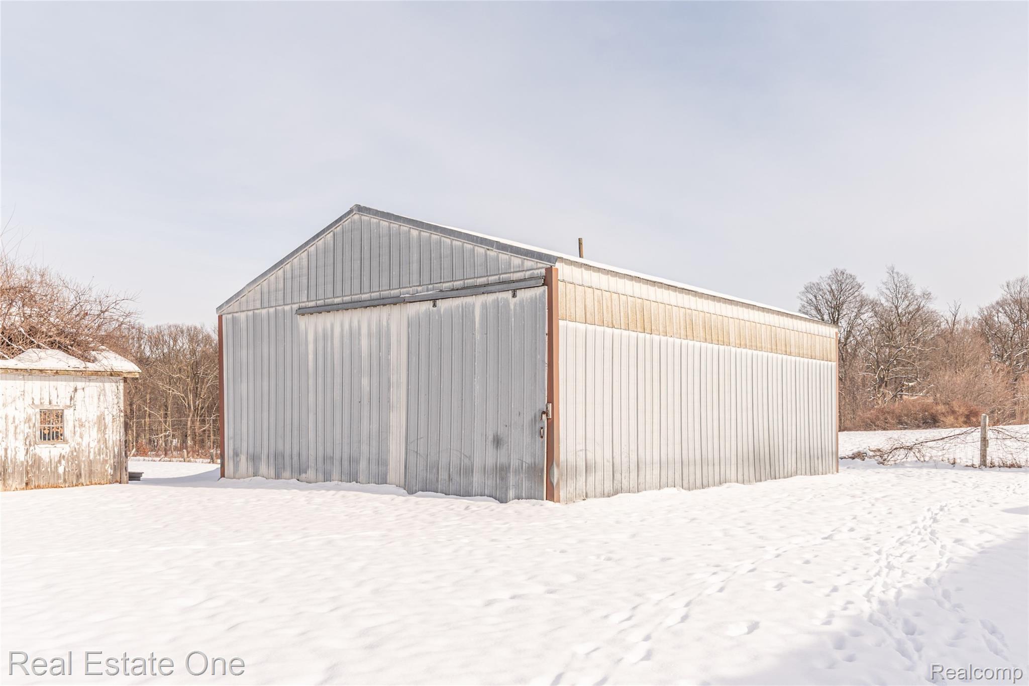 22700 Griswold Road South Lyon, MI 48178 - Photo 10 of 51 Snow covered structure featuring an outbuilding