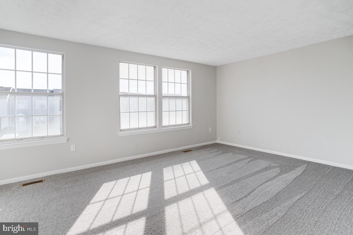 1308 Apple Ridge Court Edgewood, MD 21040 - Photo 18 of 38 an empty room with wooden floor and windows
