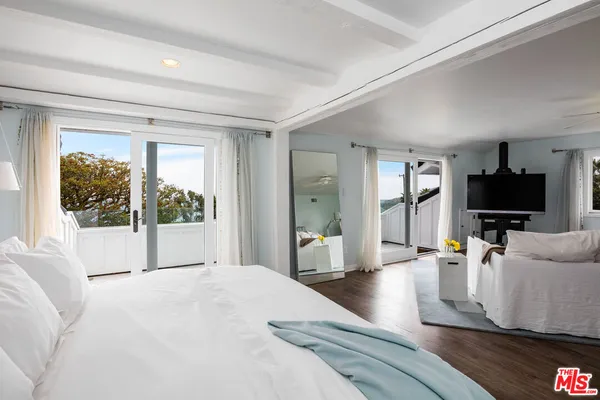 a bedroom with a bed and large window