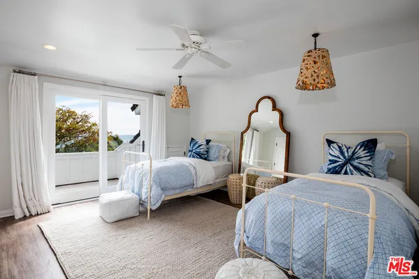 a bedroom with two beds and a window