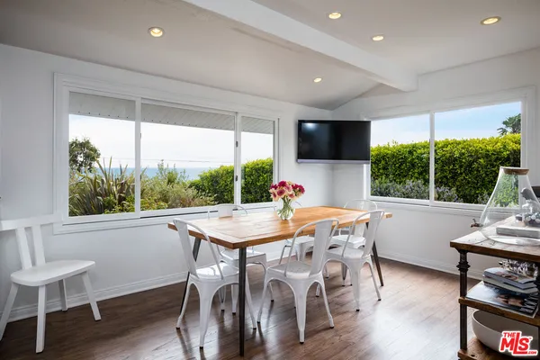a view of a dining room with furniture window and wooden floor