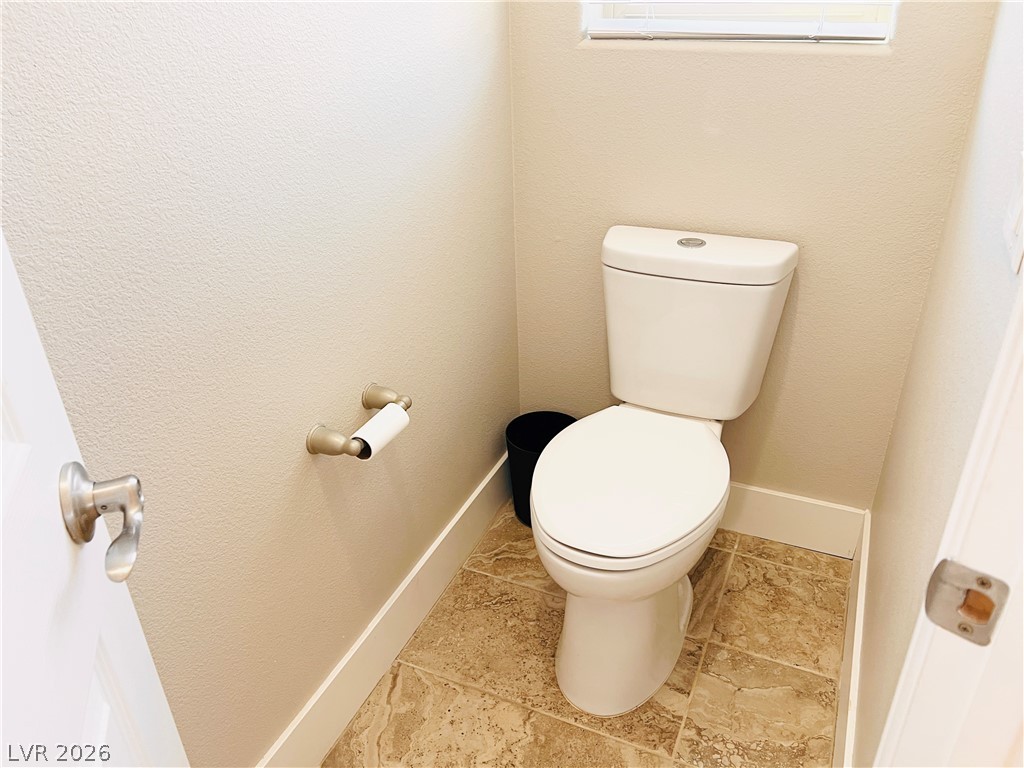 161 Dunblane Street Henderson, NV 89012 - Photo 49 of 56 Functional powder room with durable tile flooring and a discreet window for natural illumination.
