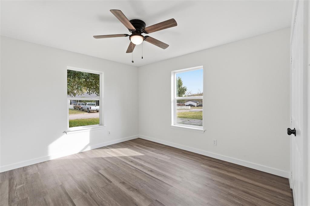 513 Paddy Street Mesquite, TX 75149 - Photo 11 of 18 a view of an empty room with wooden floor and a window
