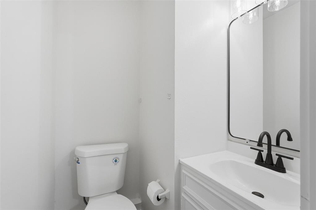 513 Paddy Street Mesquite, TX 75149 - Photo 16 of 18 a bathroom with a toilet sink and mirror