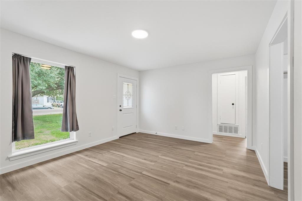 513 Paddy Street Mesquite, TX 75149 - Photo 4 of 18 a view of an empty room with wooden floor and a window
