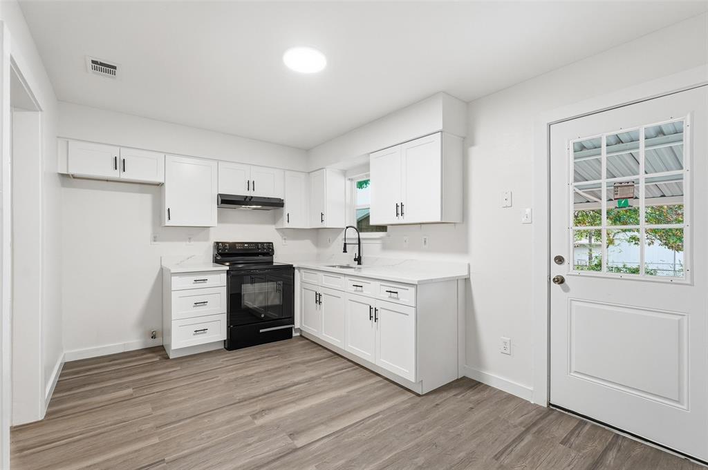 513 Paddy Street Mesquite, TX 75149 - Photo 6 of 18 a kitchen with a stove top oven sink and cabinets