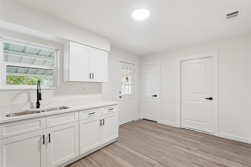 513 Paddy Street Mesquite, TX 75149 - Photo 8 of 18 a kitchen with white cabinets and sink