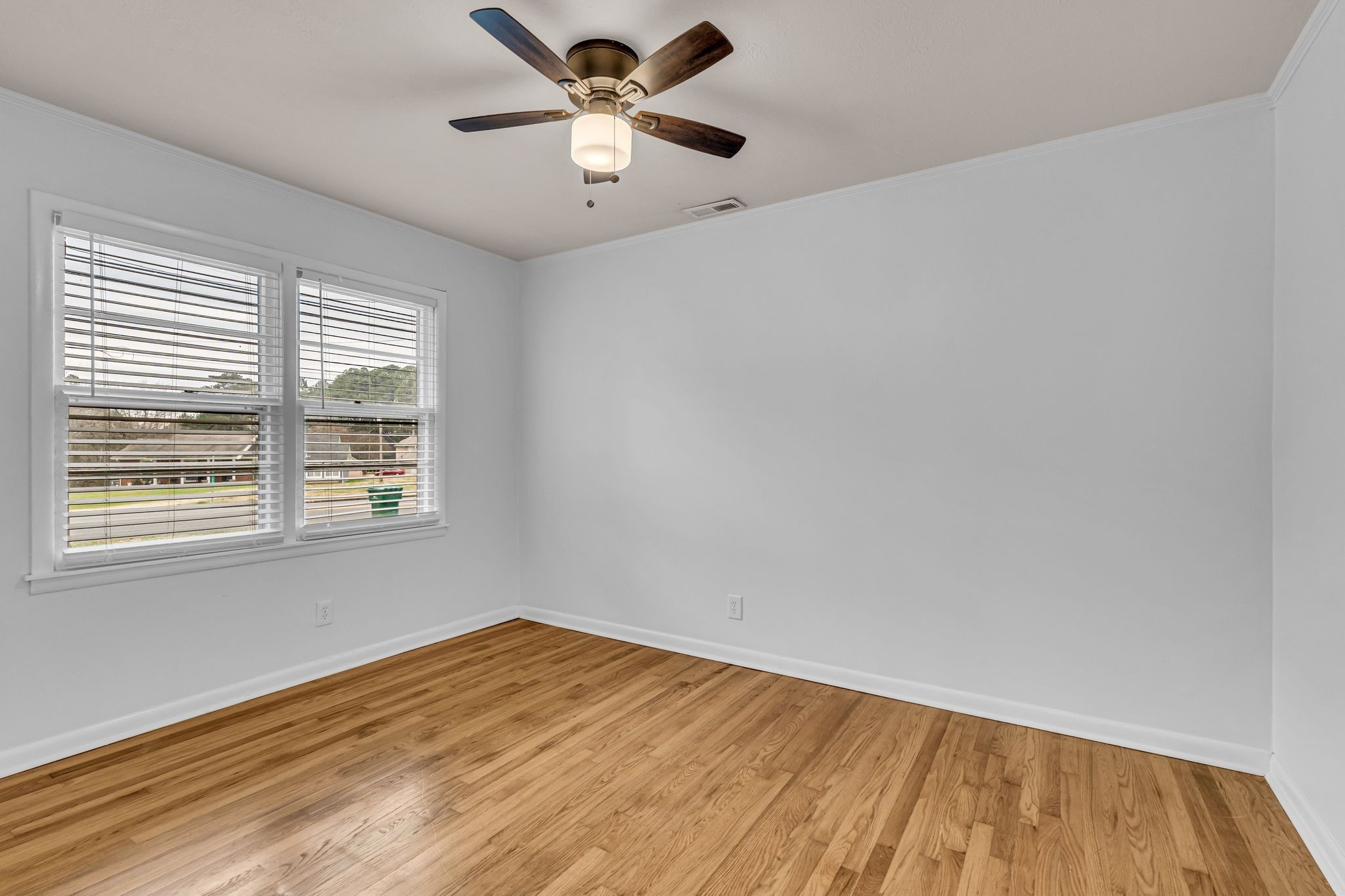 1102 North High Street Winchester, TN 37398 - Photo 11 of 27 wooden floor in an empty room with a window