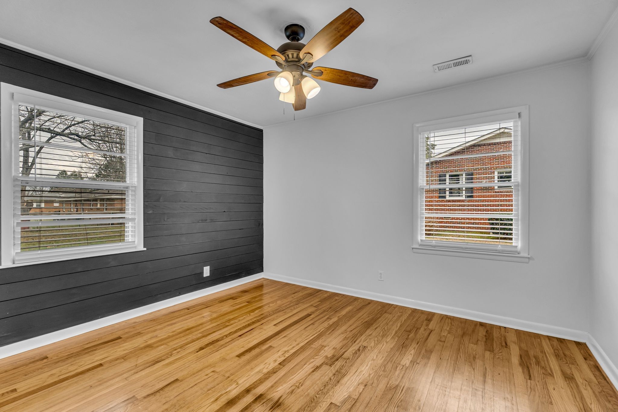 1102 North High Street Winchester, TN 37398 - Photo 12 of 27 a view of an empty room with wooden floor and a window