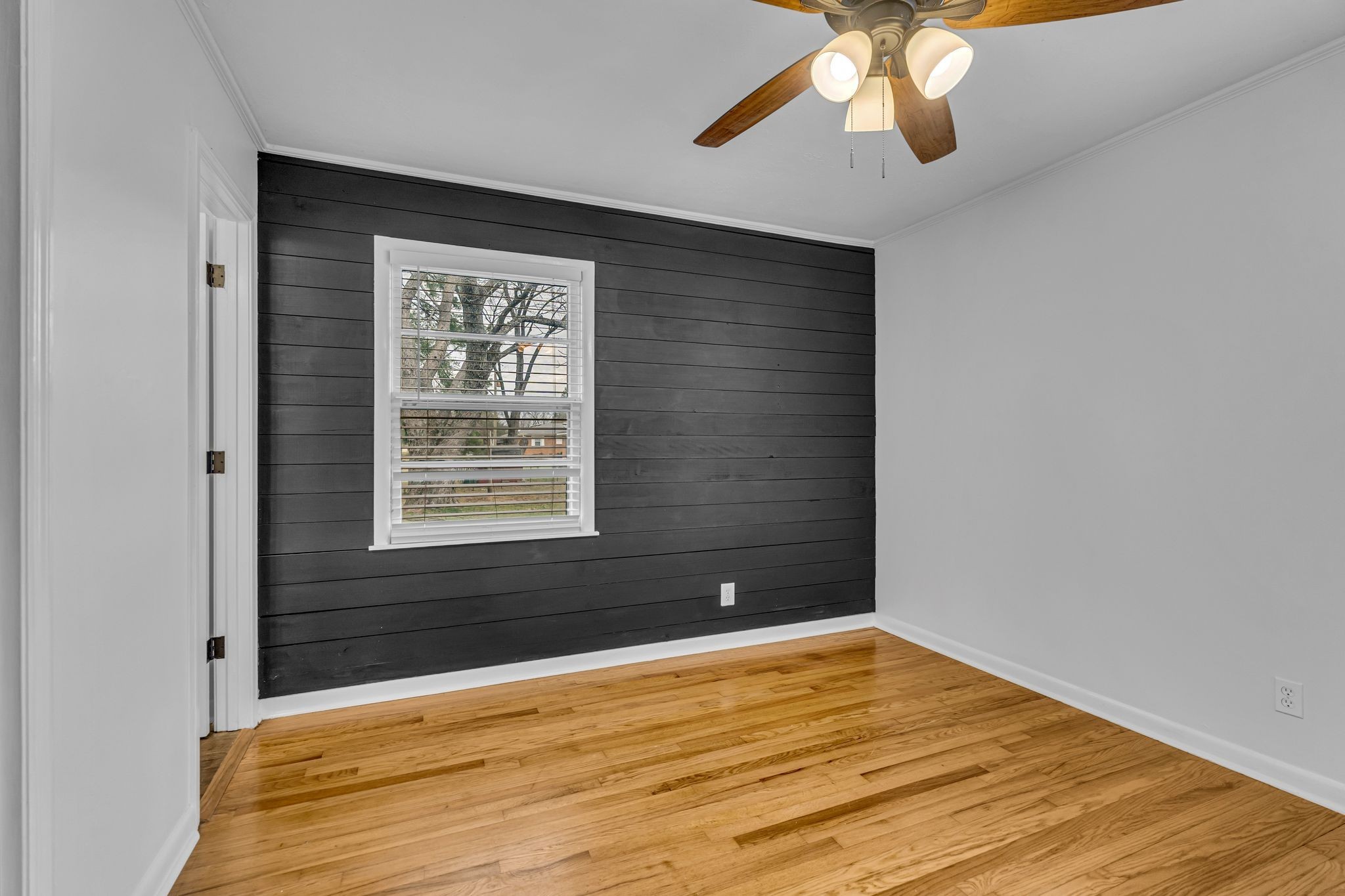 1102 North High Street Winchester, TN 37398 - Photo 13 of 27 a view of an empty room with wooden floor and a window