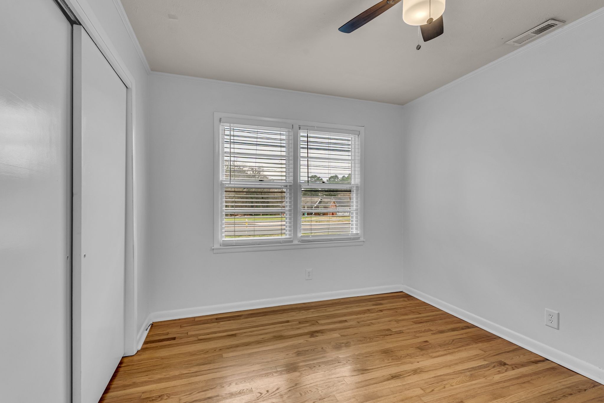 1102 North High Street Winchester, TN 37398 - Photo 15 of 27 a view of an empty room with wooden floor and a window