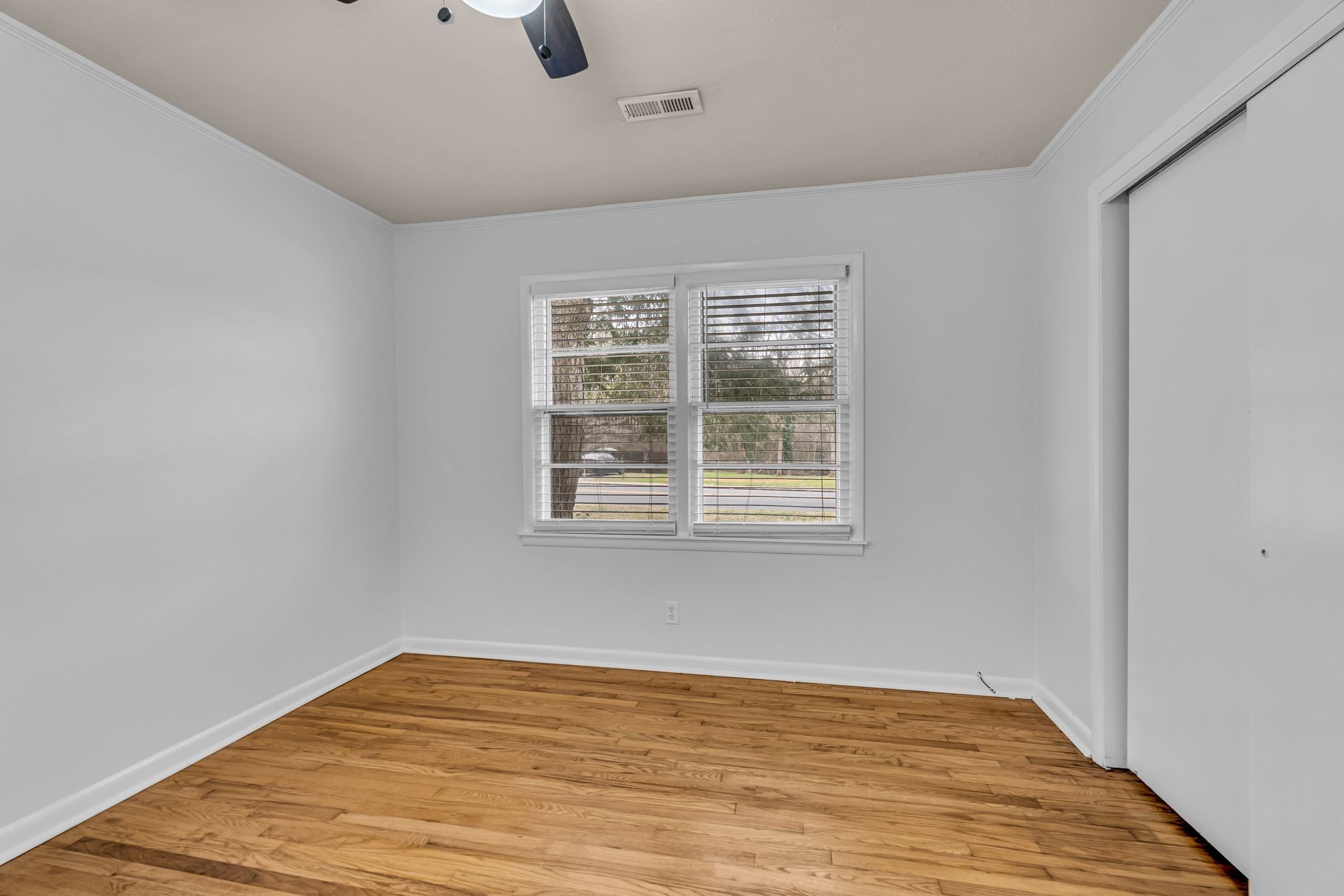 1102 North High Street Winchester, TN 37398 - Photo 16 of 27 wooden floor in an empty room with a window