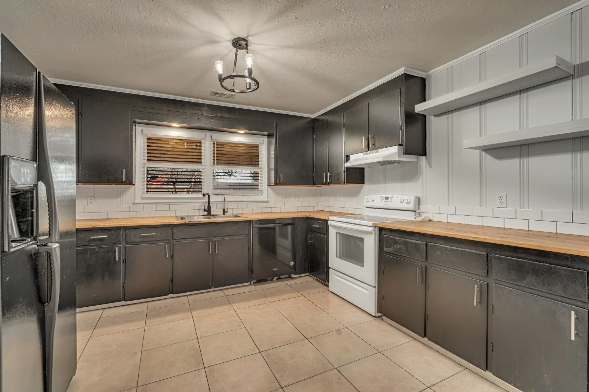 1102 North High Street Winchester, TN 37398 - Photo 5 of 27 a kitchen with a sink window and cabinets