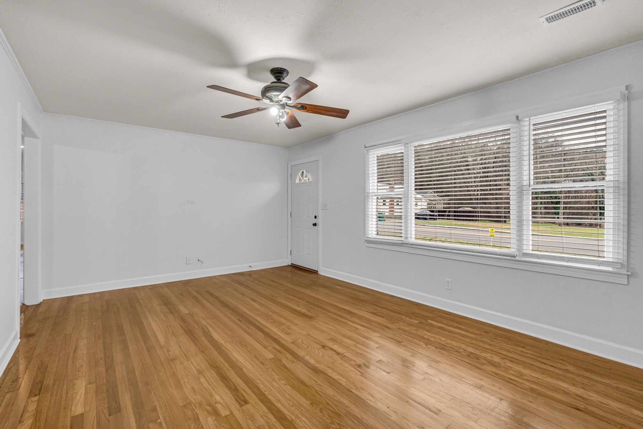 1102 North High Street Winchester, TN 37398 - Photo 9 of 27 a view of empty room with wooden floor and fan