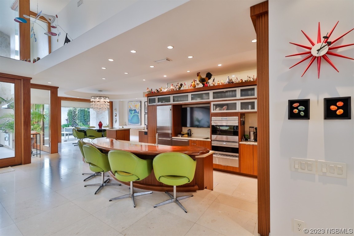 1006 South Riverside Drive Edgewater, FL 32132 - Photo 11 of 75 a living room with furniture a flat screen tv and a table