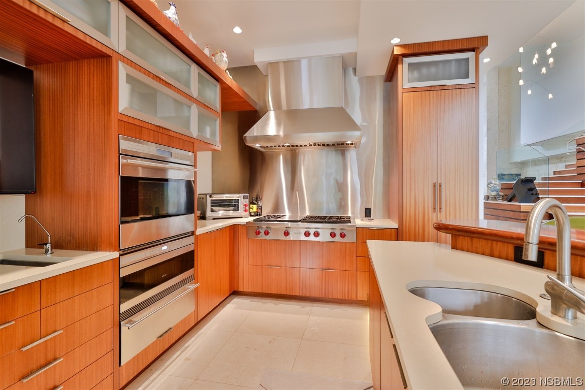 1006 South Riverside Drive Edgewater, FL 32132 - Photo 12 of 75 a kitchen with stainless steel appliances granite countertop a sink and a refrigerator
