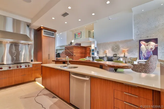 a view of a swimming pool with couches chairs and a potted plant