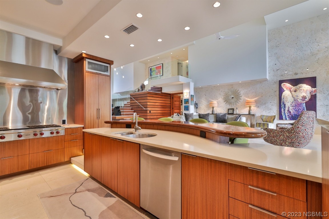 1006 South Riverside Drive Edgewater, FL 32132 - Photo 15 of 75 a kitchen with stainless steel appliances granite countertop a sink and cabinets