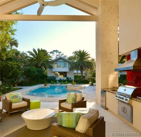 a kitchen with stainless steel appliances kitchen island granite countertop a sink and a stove