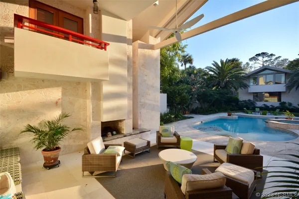 a living room with furniture and a view of kitchen