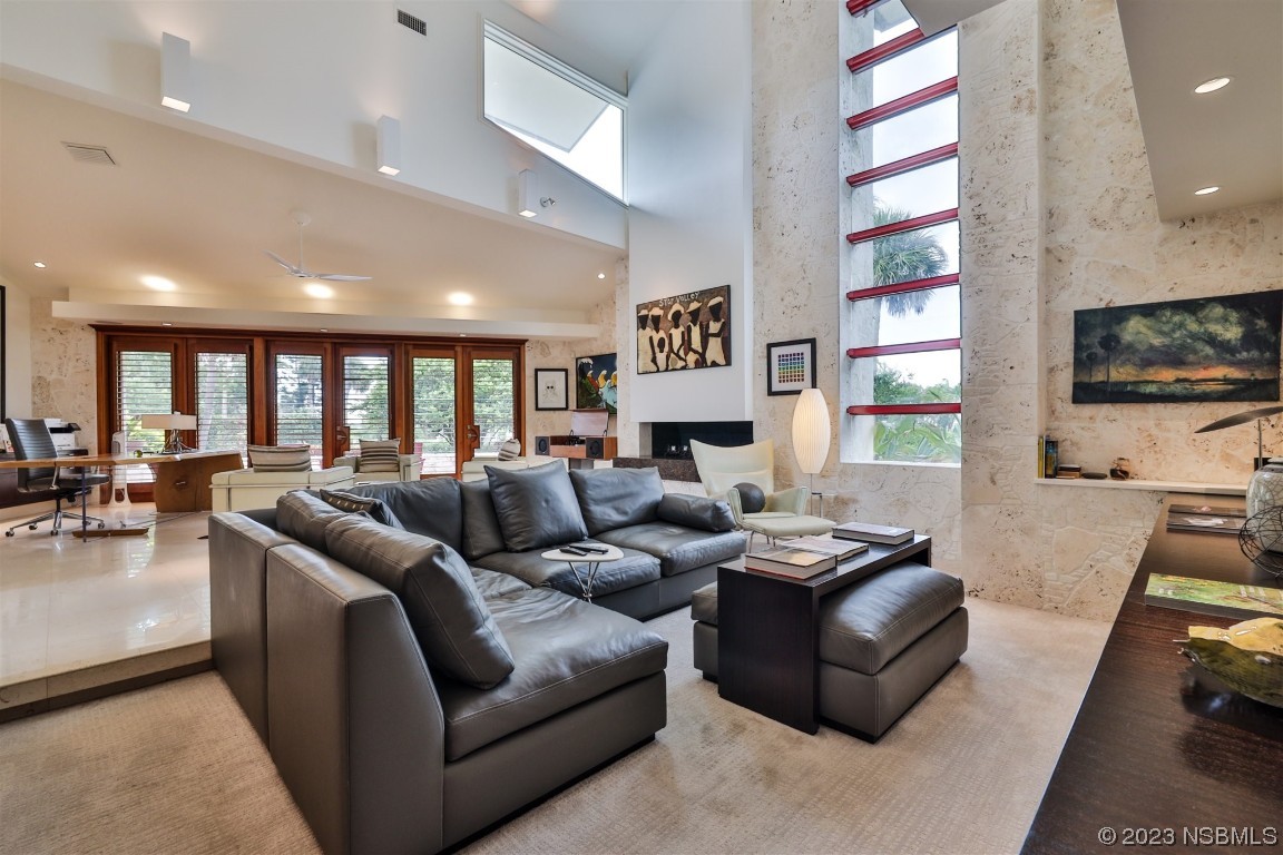1006 South Riverside Drive Edgewater, FL 32132 - Photo 25 of 75 a living room with furniture and a flat screen tv