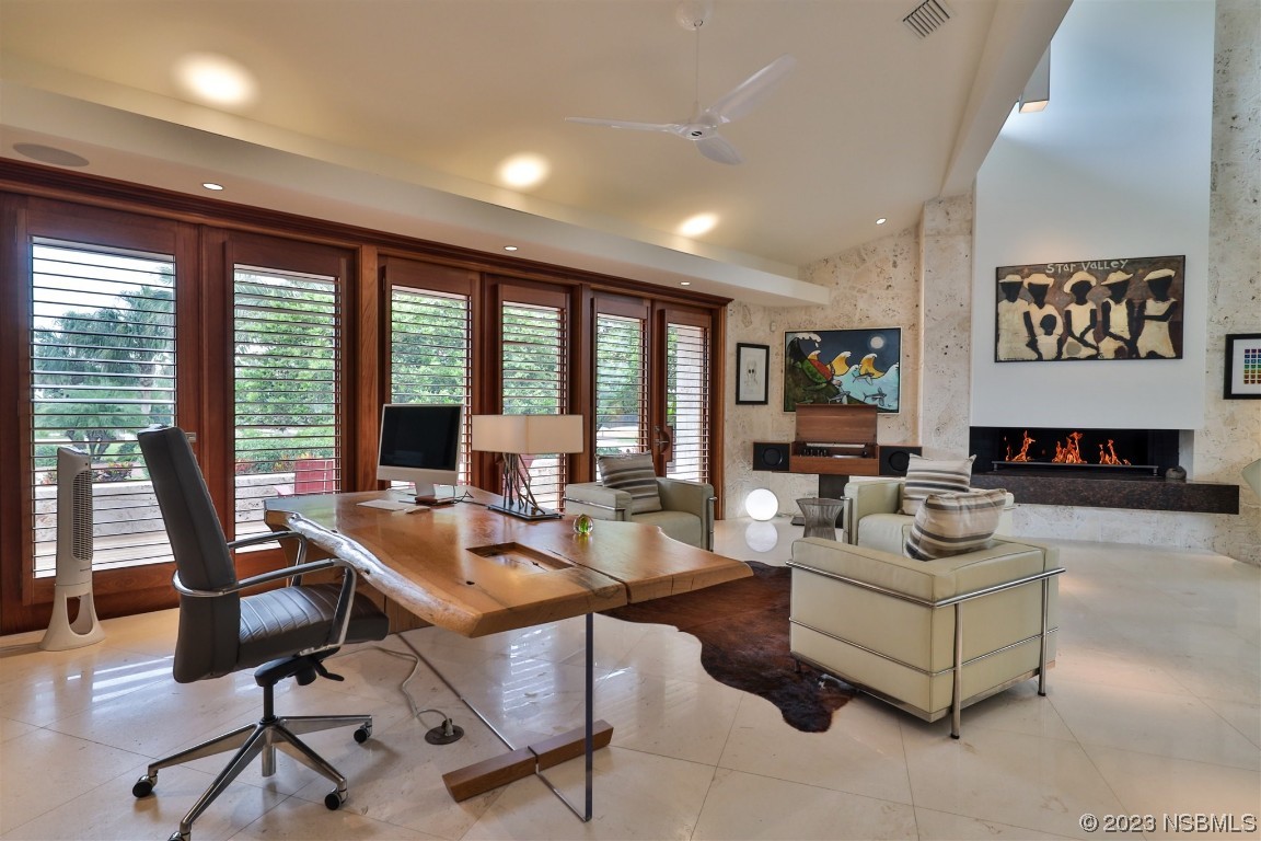 1006 South Riverside Drive Edgewater, FL 32132 - Photo 30 of 75 a living room with fireplace furniture and floor to ceiling window