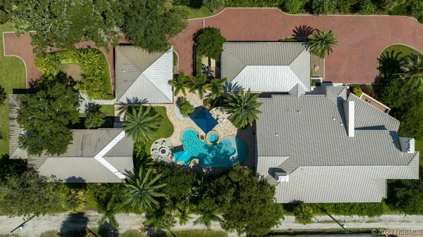 an aerial view of a house with a yard and garden