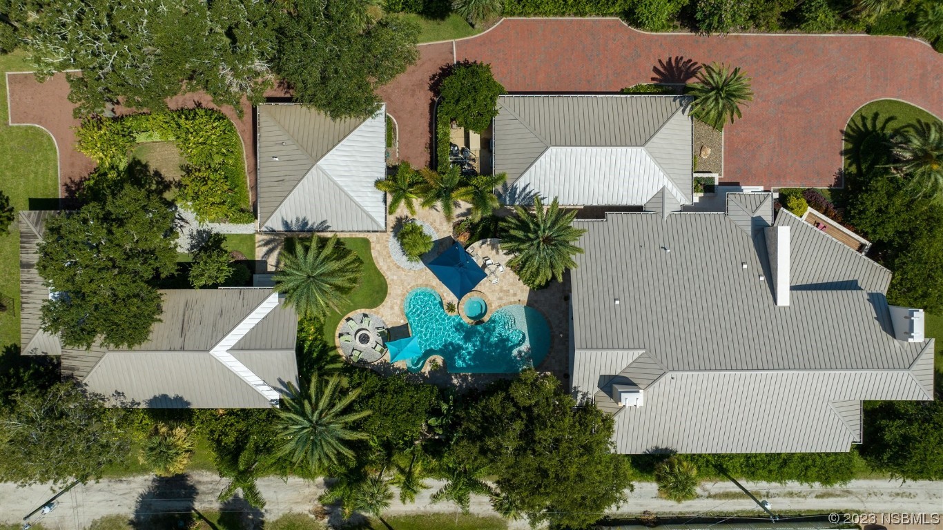 1006 South Riverside Drive Edgewater, FL 32132 - Photo 3 of 75 an aerial view of a house with a yard and garden