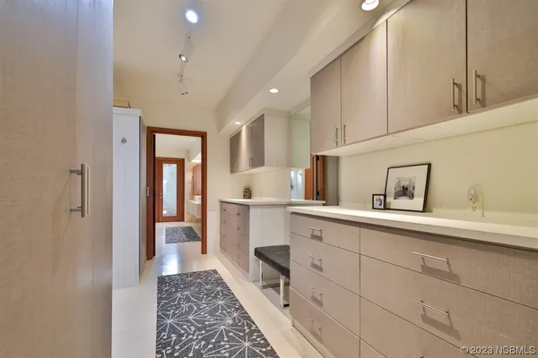 a view of a swimming pool with plants and palm trees