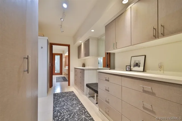 a view of a swimming pool with plants and palm trees