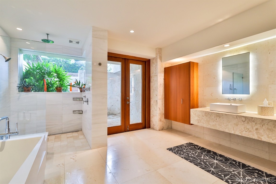 1006 South Riverside Drive Edgewater, FL 32132 - Photo 36 of 75 a bathroom with a tub shower and sink