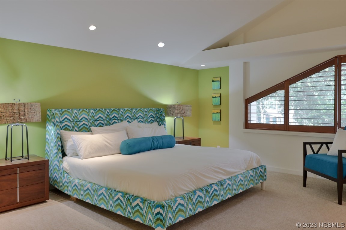 1006 South Riverside Drive Edgewater, FL 32132 - Photo 40 of 75 a bedroom with a bed lamps and a large window