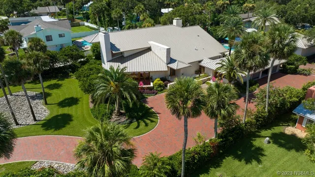 an aerial view of a house with garden space and street view