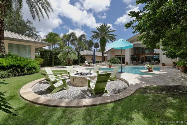 a living room with lots of furniture and kitchen view