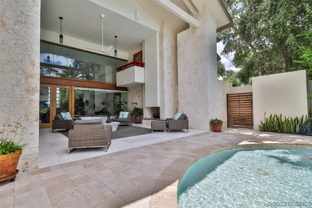 a living room with lots of furniture and baby bed
