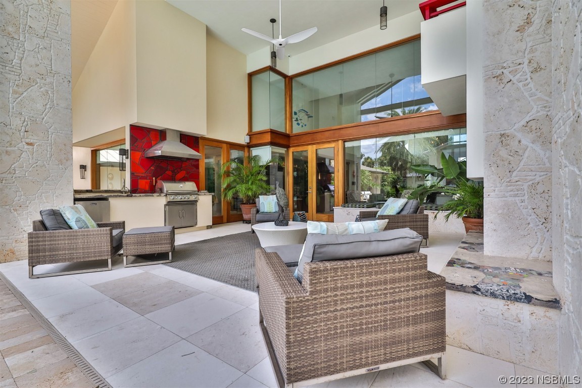 1006 South Riverside Drive Edgewater, FL 32132 - Photo 50 of 75 a living room with furniture and a floor to ceiling window