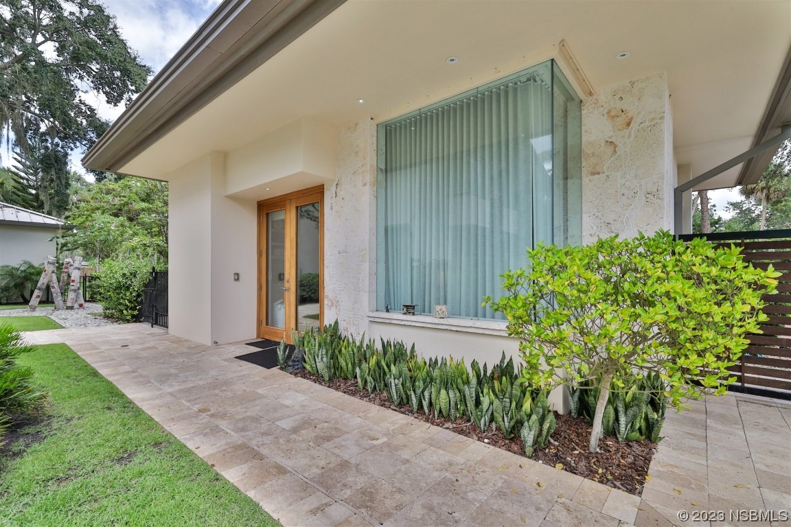 1006 South Riverside Drive Edgewater, FL 32132 - Photo 52 of 75 a front view of a house with garden