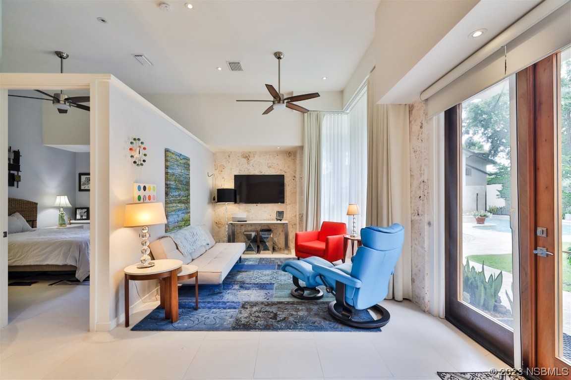 1006 South Riverside Drive Edgewater, FL 32132 - Photo 55 of 75 a living room with furniture a flat screen tv and a large window