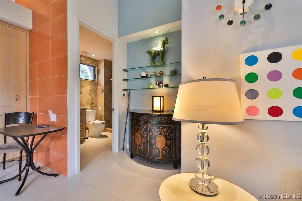 1006 South Riverside Drive Edgewater, FL 32132 - Photo 58 of 75 a living room with furniture and a chandelier