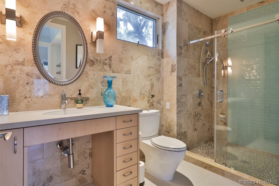 1006 South Riverside Drive Edgewater, FL 32132 - Photo 59 of 75 a bathroom with a toilet a sink and a mirror