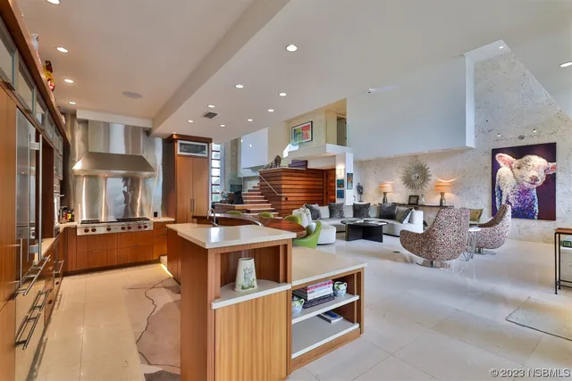 a living room with furniture a flat screen tv and a table