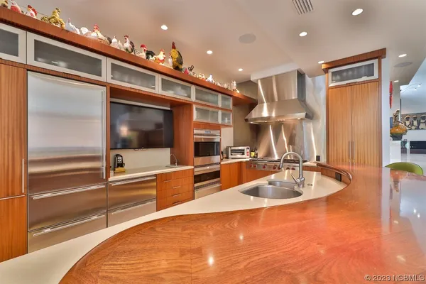 a kitchen with stainless steel appliances granite countertop a sink and a refrigerator