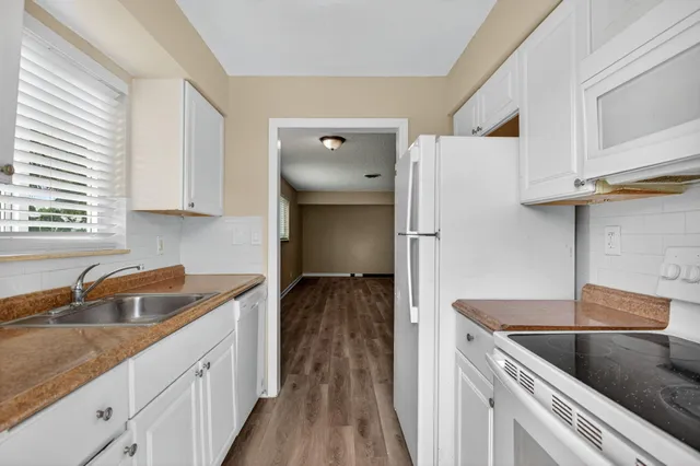 a kitchen with a sink and a refrigerator