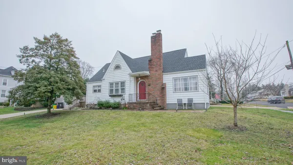 a front view of house with yard and trees
